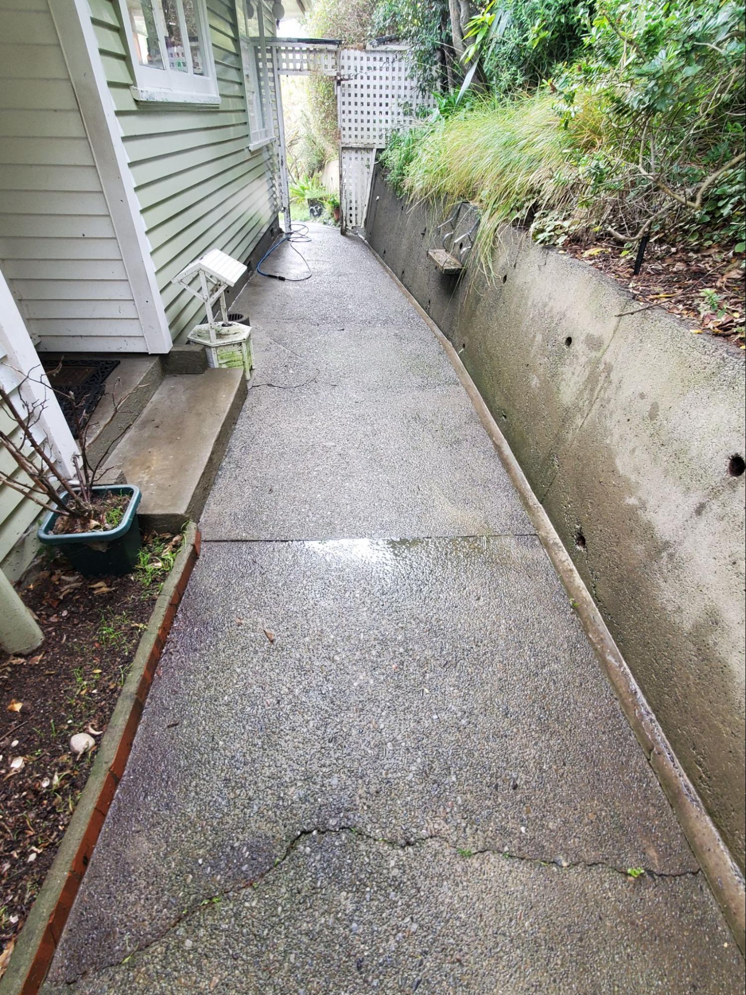 Narrow concrete pathway after water blasting