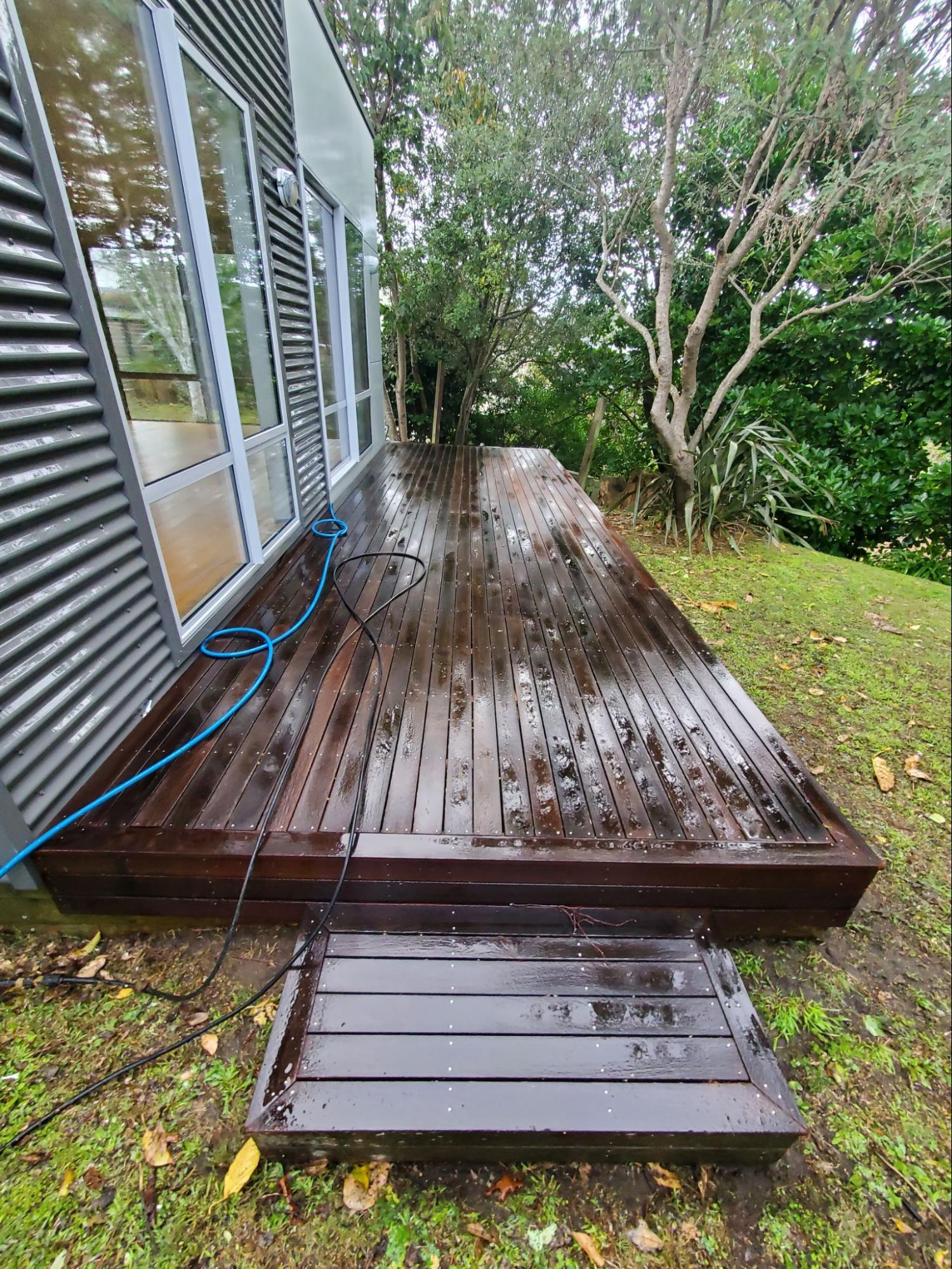 Wooden deck half cleaned during pressure washing