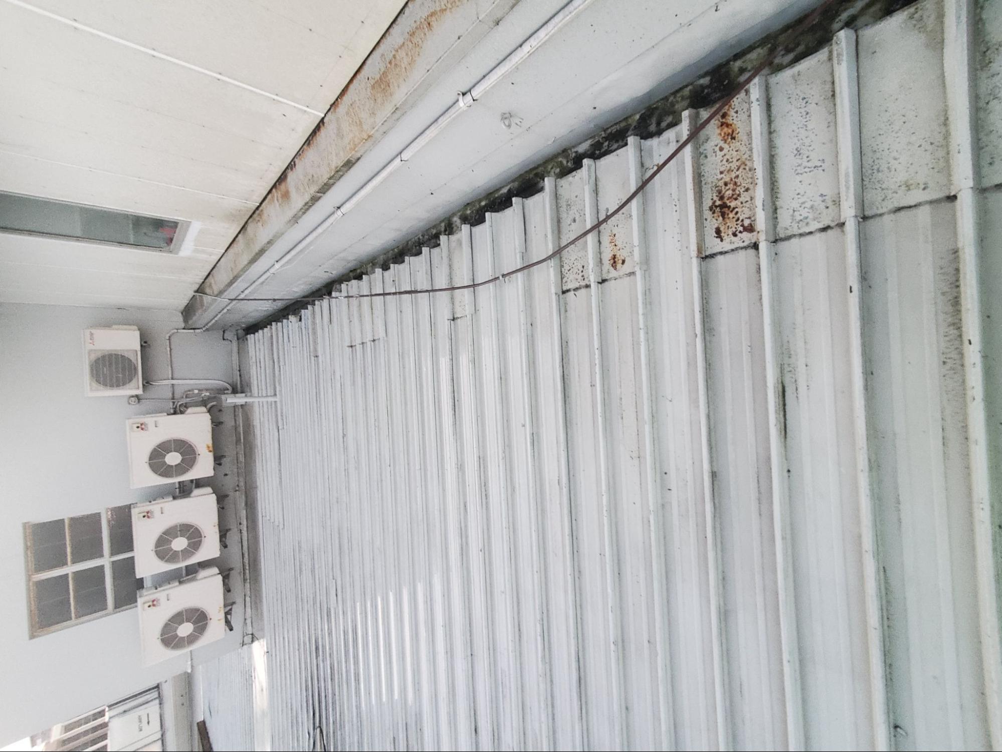Metal shed roof dirty before water blasting