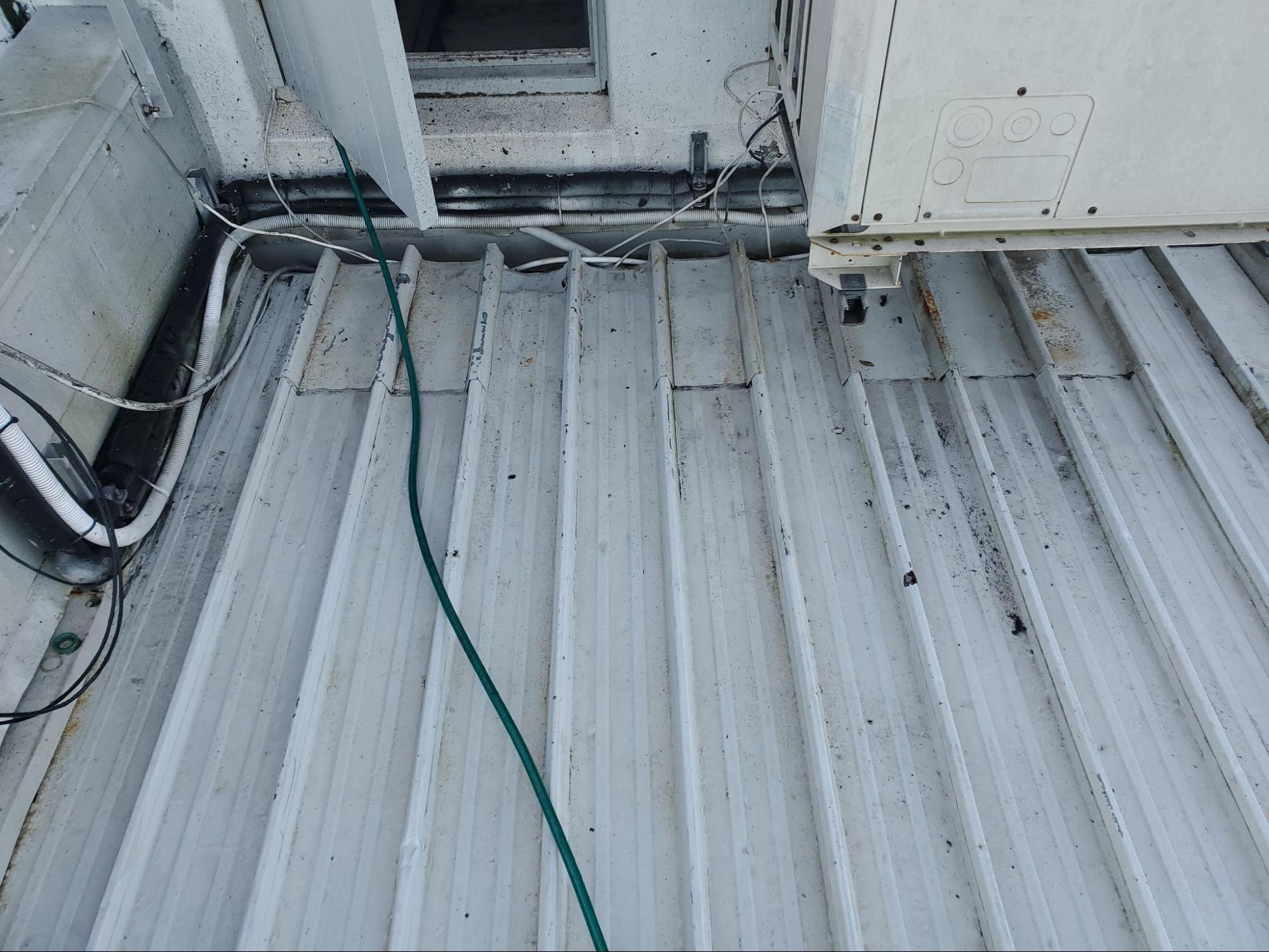 Metal rooftop clean after water blasting